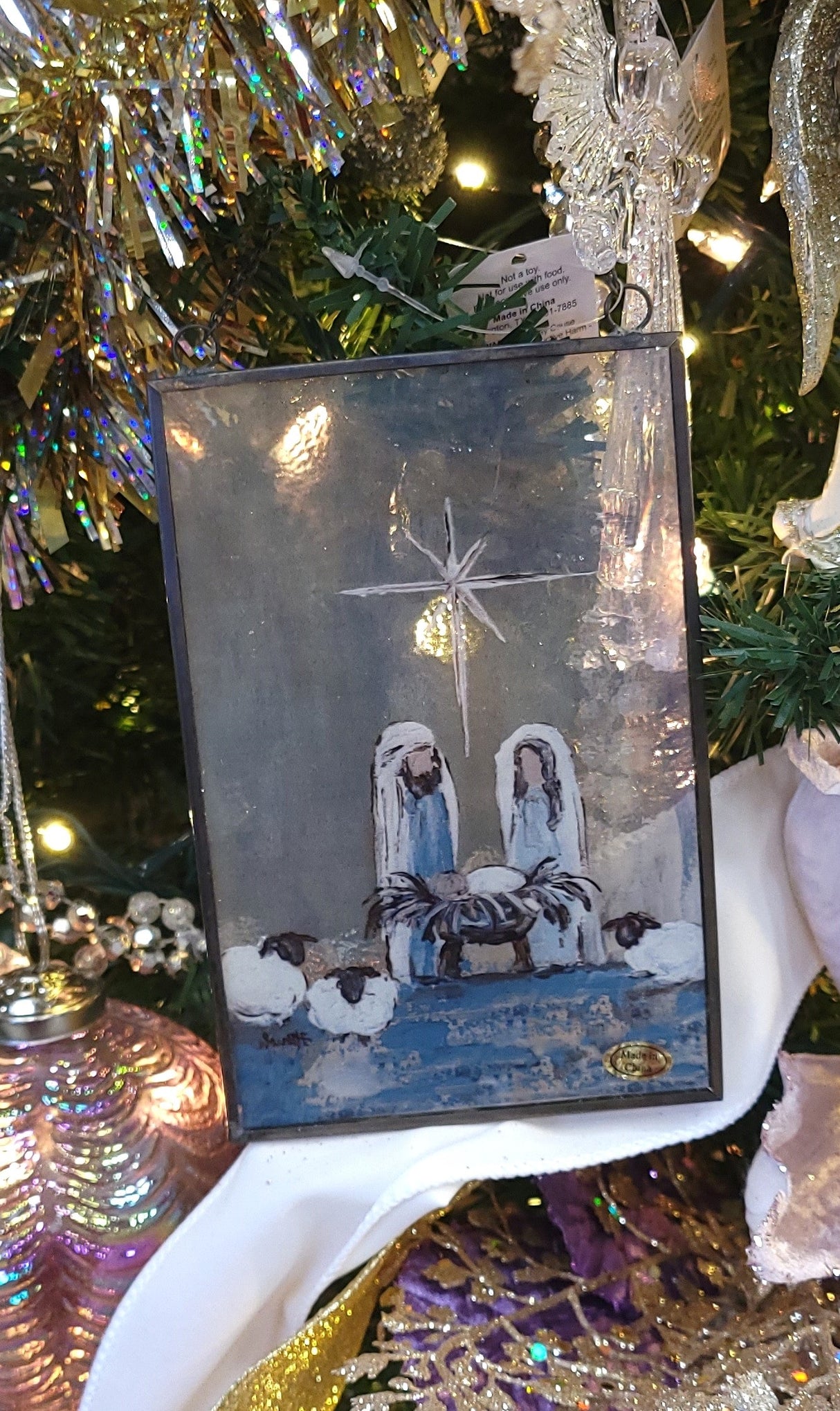 Christmas ornament with a painted Nativity Scene on it. Designed to look like stained glass.
