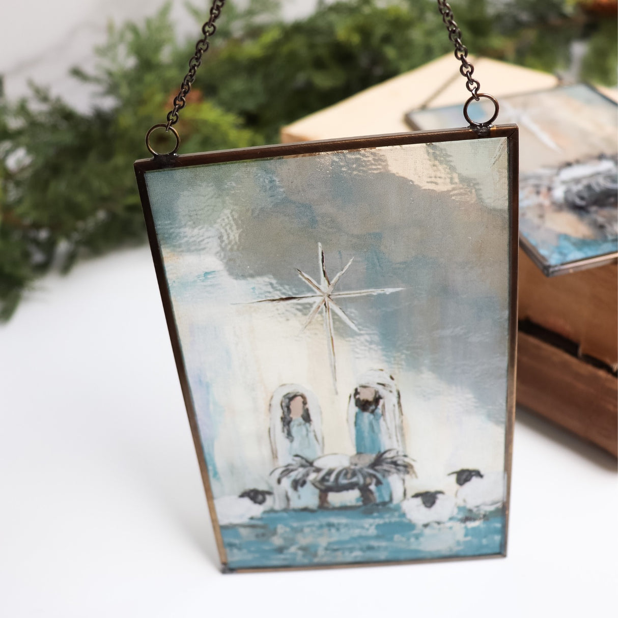 Christmas ornament with a painted Nativity Scene on it. Designed to look like stained glass.