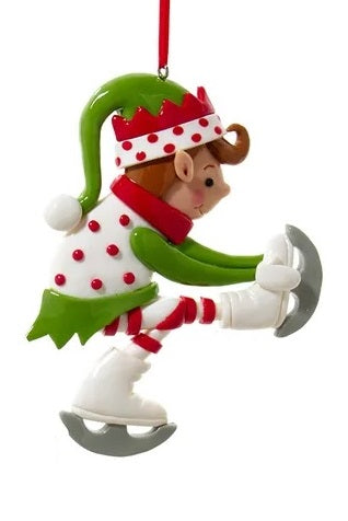 Elf ornament. There are three options. One elf is wearing a white and red polka dot jumper and ice skates. One elf is wearing a hat shaped like a tree and is holding two gifts. One elf is wearing a green jumper and wearing ice skates.