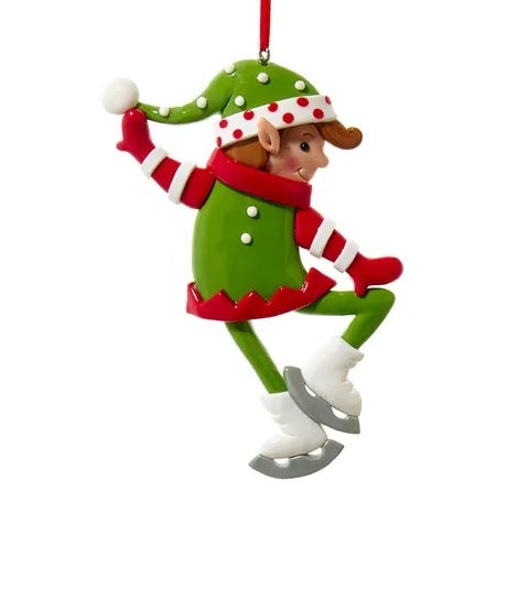 Elf ornament. There are three options. One elf is wearing a white and red polka dot jumper and ice skates. One elf is wearing a hat shaped like a tree and is holding two gifts. One elf is wearing a green jumper and wearing ice skates.
