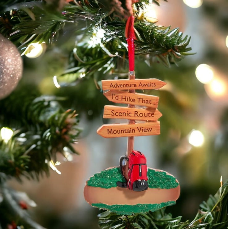Christmas ornament shaped like a hiking trail sign. Signs read "Adventure Awaits," "I'd Hike That," Scenic Route" and "Mountain View."