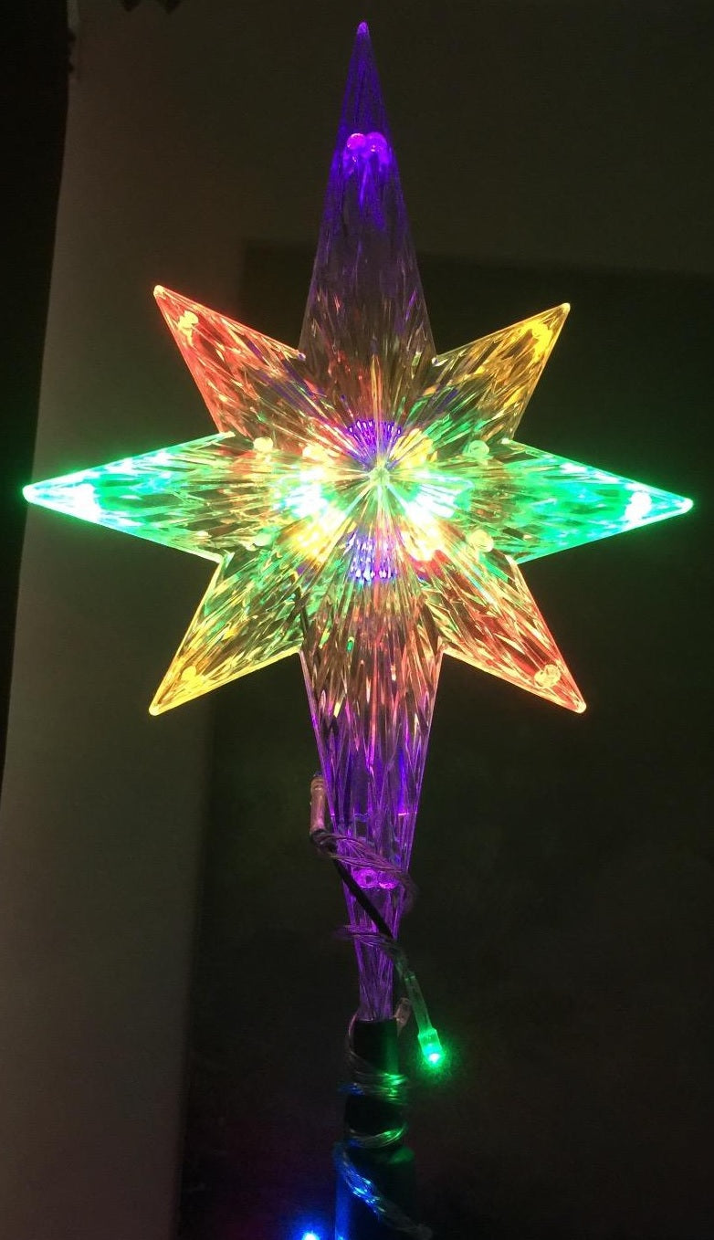 Clear Christmas tree star that shines with the color-changing LED lights inside.