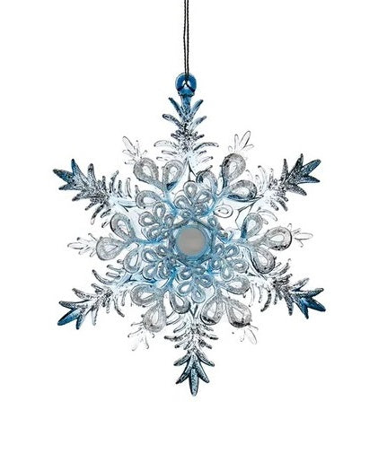 Ornaments shaped like snowflakes covered in blue and silver glitter.