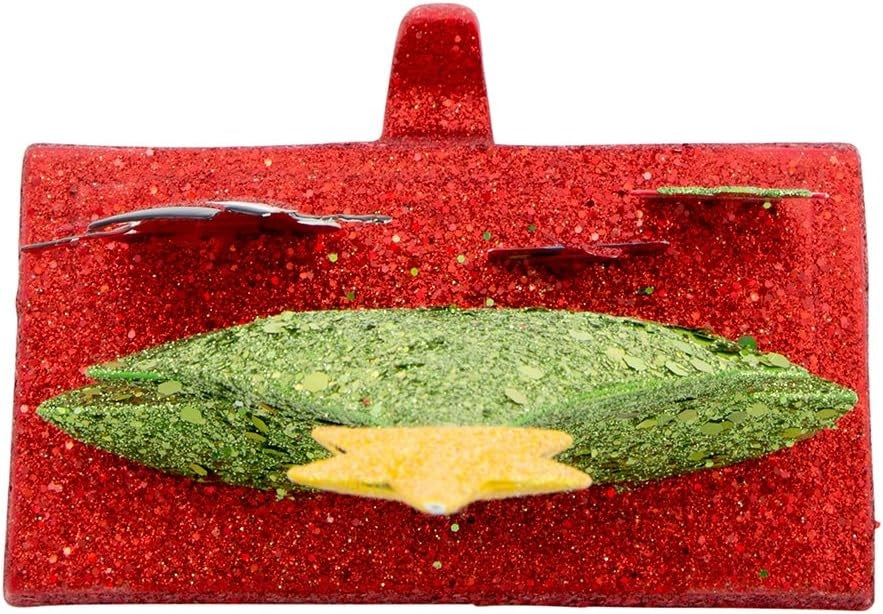 Stocking hanger covered in glitter. Designed to look like a light green tree with a yellow star on top. Next to the tree are two presents and a snowman wearing a top hat and a red scarf. The base of the holder is covered in red glitter.