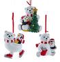 One ornament features a polar bear and a penguin decorating a Christmas tree. One ornament features a polar bear ice skating with a penguin on its back. One ornament features a polar bear and a penguin smiling over a red bucket of fish. Each ornament hangs from a red ribbon.