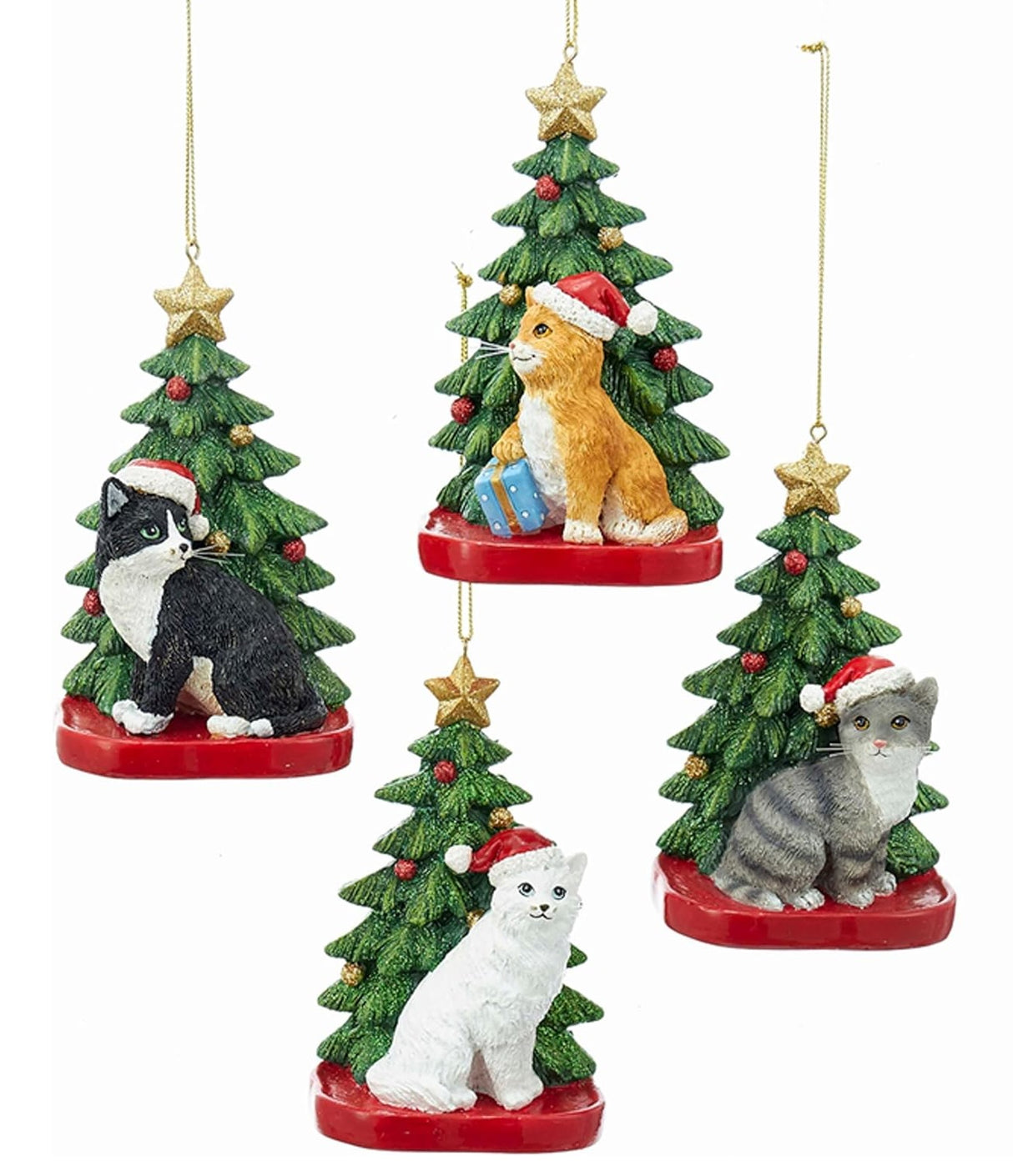 Ornaments shaped like a cat in front of a tree. One ornament features a black and white cat. One ornament features an orange and white cat. One ornament features a light gray and dark gray cat. One ornament features a white cat. All the cats are wearing Santa hats.