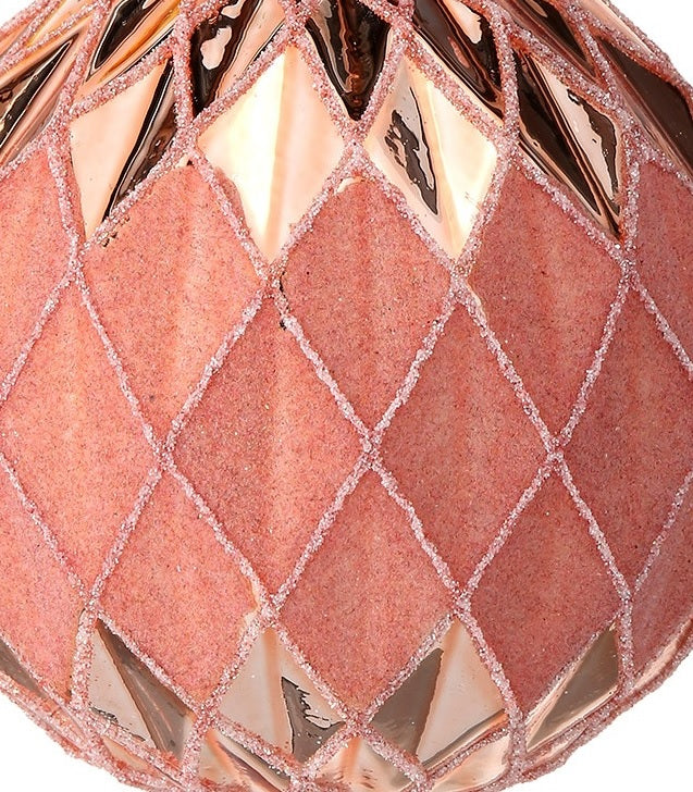 Round bauble ornament. Features a unique textured design. Different hues of the color pink.