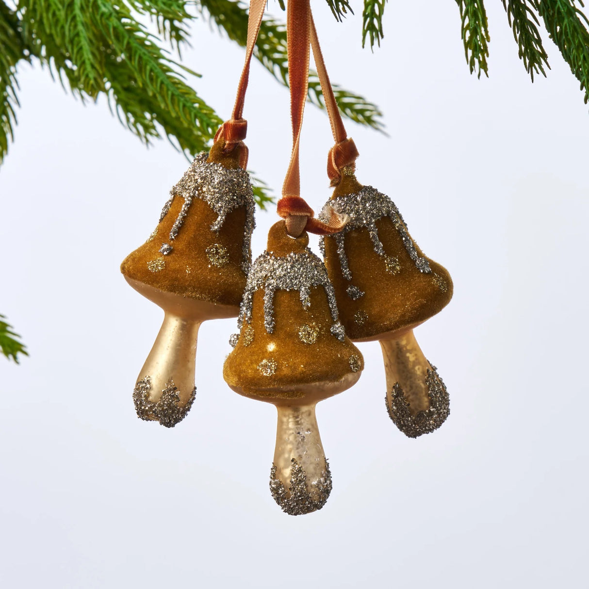 Ornament consisting of three mushrooms. The colors are aged moss, gold and silver.