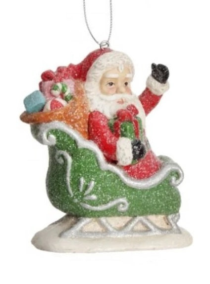 Santa Claus figurine Christmas Ornament. One ornament features Santa in a sleigh. One ornament features Santa in a chimney.