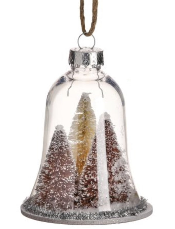 Ornament shaped like a glass bell with small bottle brush trees inside. One ornament features two green trees and one yellow tree. One ornament features two reddish brown trees and one yellow tree. All the trees are designed to appear covered in snow. Each ornament features tinsel around the border.