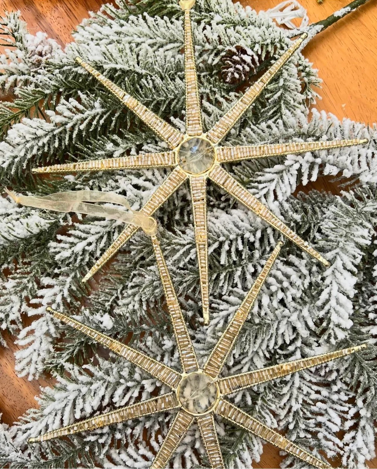 Golden ornament shaped like a star made out of wires.