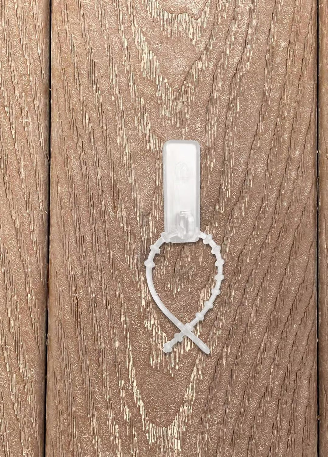 This is a lifestyle image showing the light tie attached to a piece of wood.