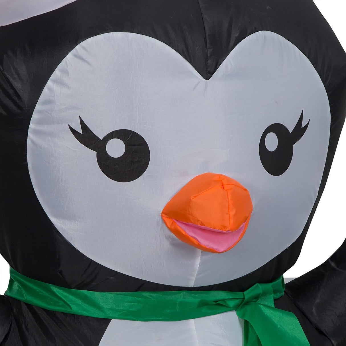 Christmas inflatable designed to look like a cute penguin wearing a Santa hat and a green scarf.