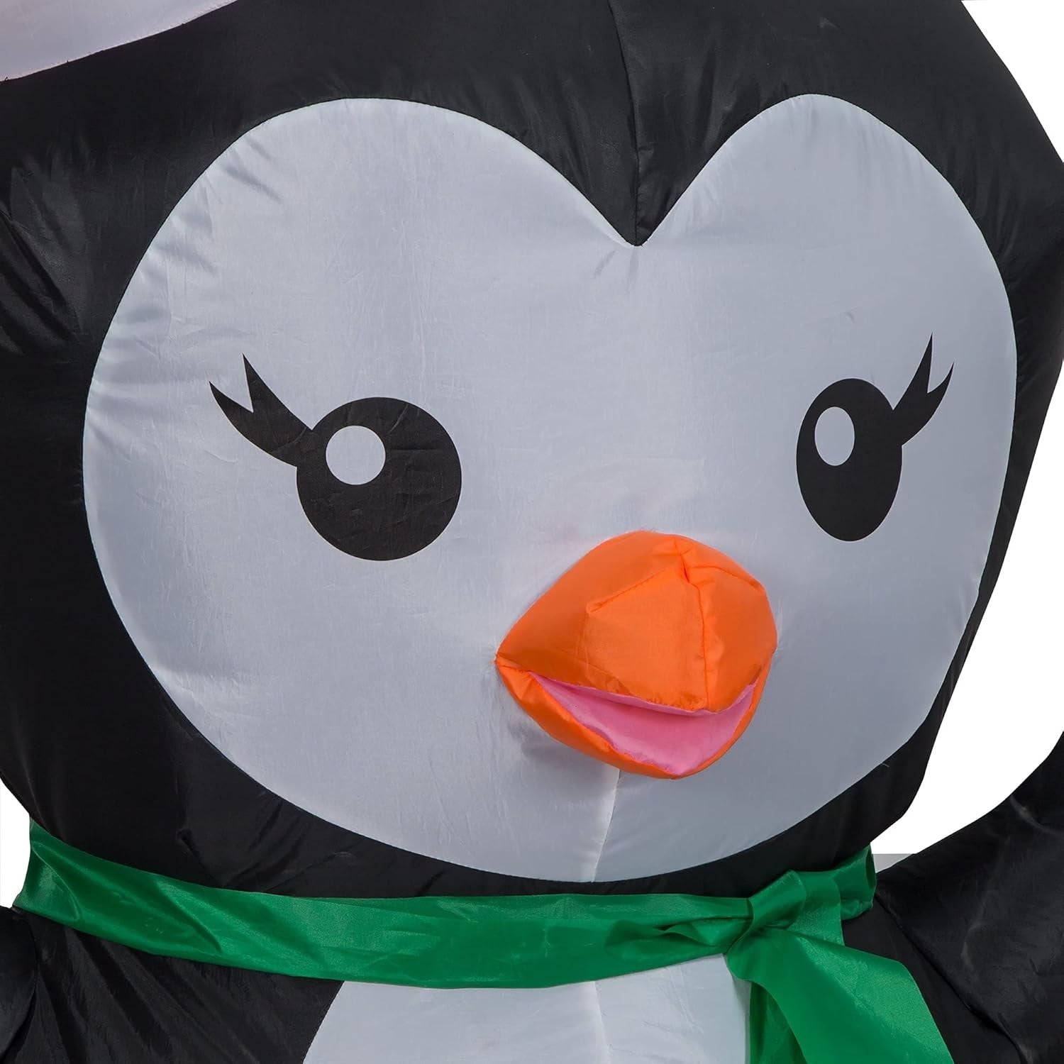 Christmas inflatable designed to look like a cute penguin wearing a Santa hat and a green scarf.