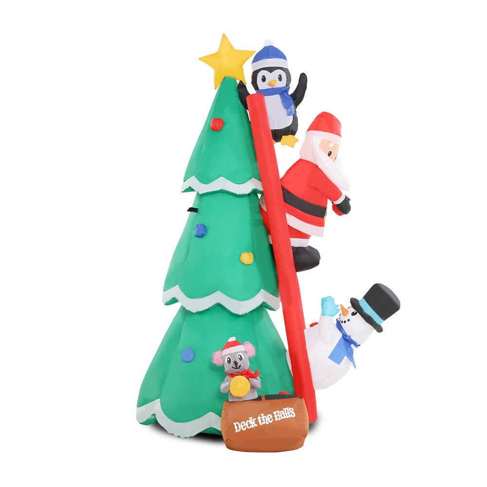 Christmas inflatable shaped like a penguin, Santa and a snowman climbing a red ladder leaning up against a Christmas tree. They're putting the finishing touches on the tree decorating. There's a little box at the bottom with a mouse holding an ornament. The box reads "DECK THE HALLS."