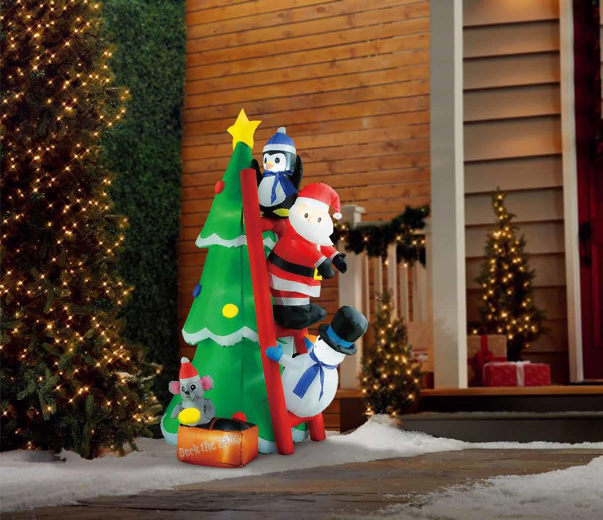 Christmas inflatable shaped like a penguin, Santa and a snowman climbing a red ladder leaning up against a Christmas tree. They're putting the finishing touches on the tree decorating. There's a little box at the bottom with a mouse holding an ornament. The box reads "DECK THE HALLS."