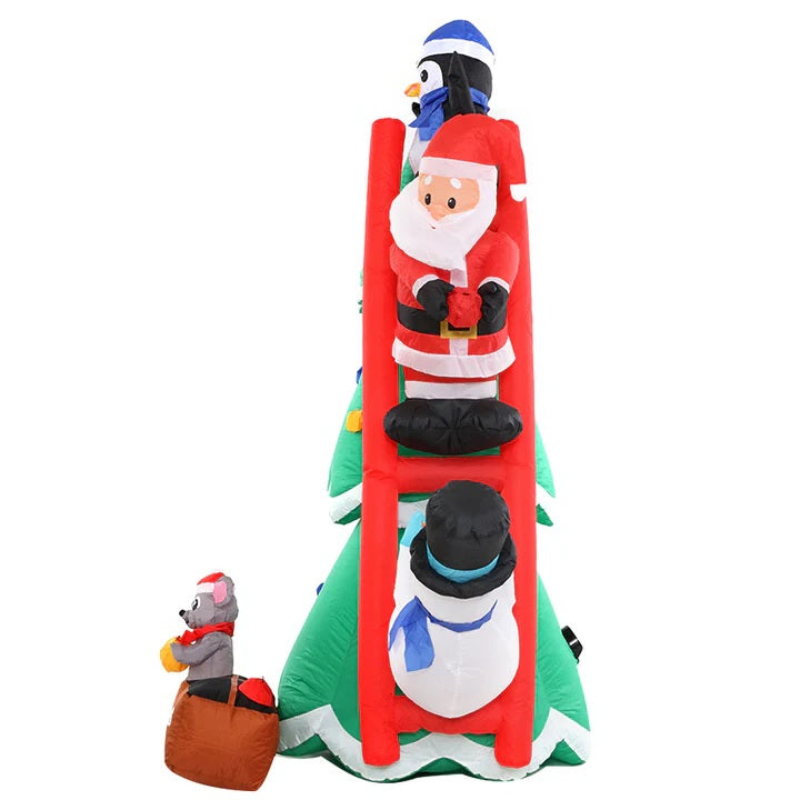 Christmas inflatable shaped like a penguin, Santa and a snowman climbing a red ladder leaning up against a Christmas tree. They're putting the finishing touches on the tree decorating. There's a little box at the bottom with a mouse holding an ornament. The box reads "DECK THE HALLS."