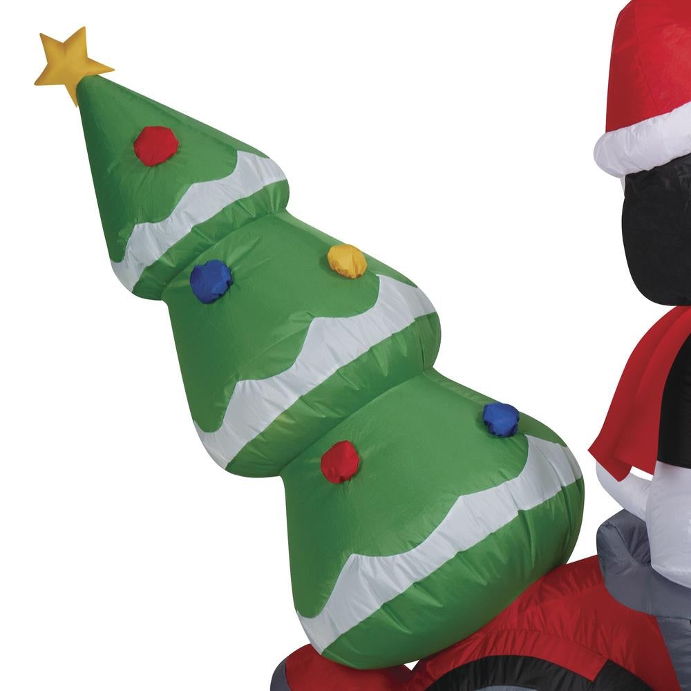 Christmas inflatable. It features Snoopy wearing a Santa hat and wearing sunglasses. Snoopy is driving a red motorcycle with a snowflake accent on it. There's a decorated Christmas tree on the back and Woodstock is riding on the handlebars. There are LED lights inside.