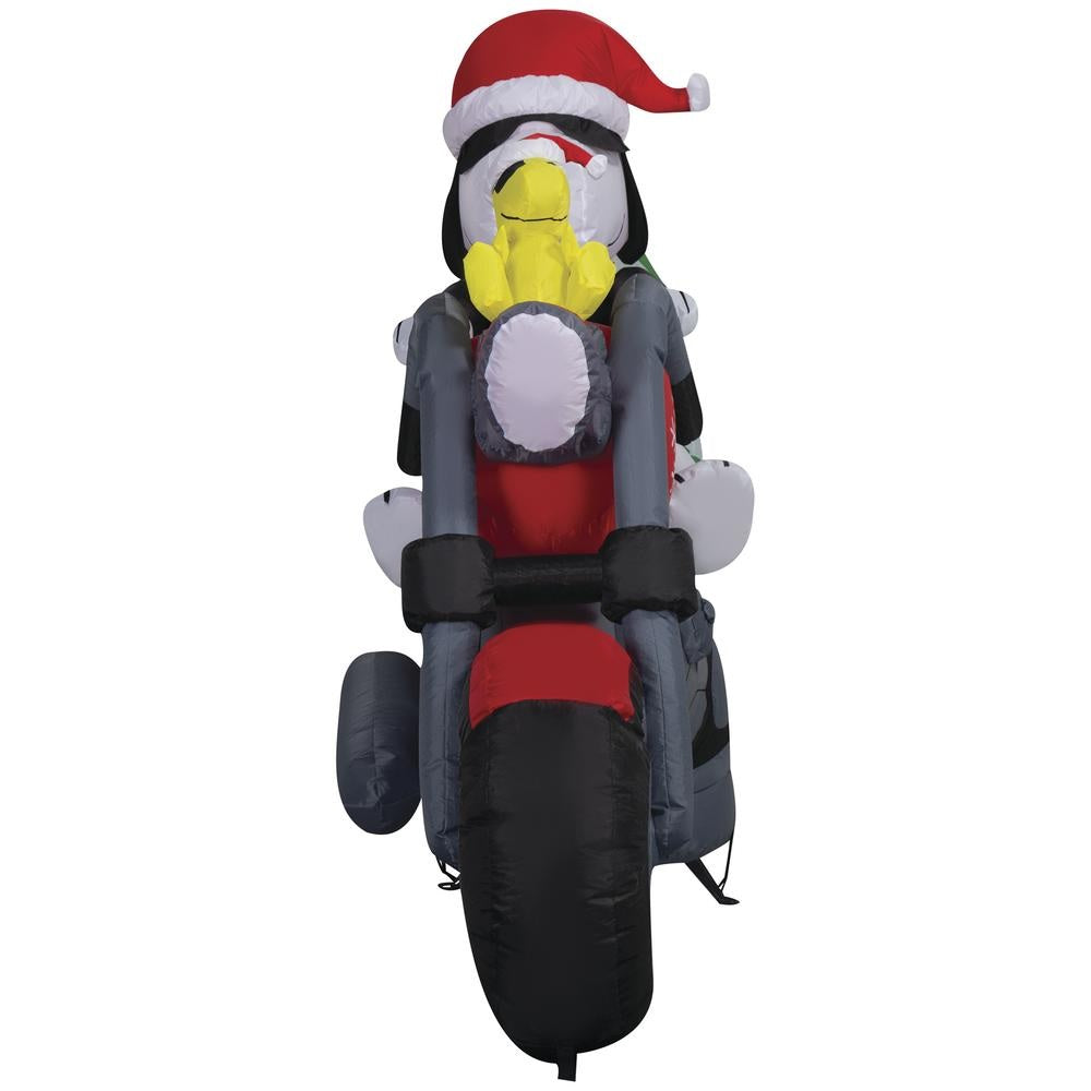 Christmas inflatable. It features Snoopy wearing a Santa hat and wearing sunglasses. Snoopy is driving a red motorcycle with a snowflake accent on it. There's a decorated Christmas tree on the back and Woodstock is riding on the handlebars. There are LED lights inside.