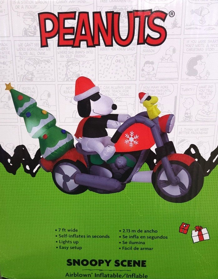 Christmas inflatable. It features Snoopy wearing a Santa hat and wearing sunglasses. Snoopy is driving a red motorcycle with a snowflake accent on it. There's a decorated Christmas tree on the back and Woodstock is riding on the handlebars. There are LED lights inside.
