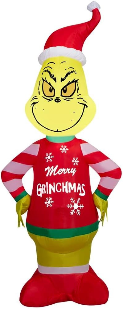 Christmas inflatable shaped like the cartoon character The Grinch. The Grinch is wearing a Santa hat and an "ugly" sweater that reads "Merry Grinchmas." The sleeves on the sweater are red and white striped.