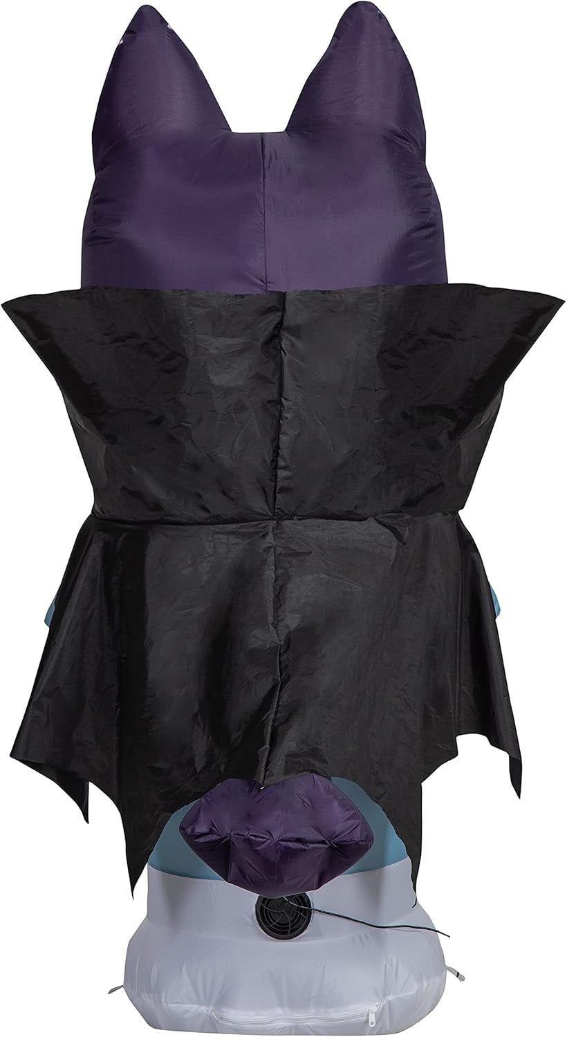 Halloween inflatable shaped like the cartoon character Bluey. He's dressed as a vampire and holding a jack-o-lantern.