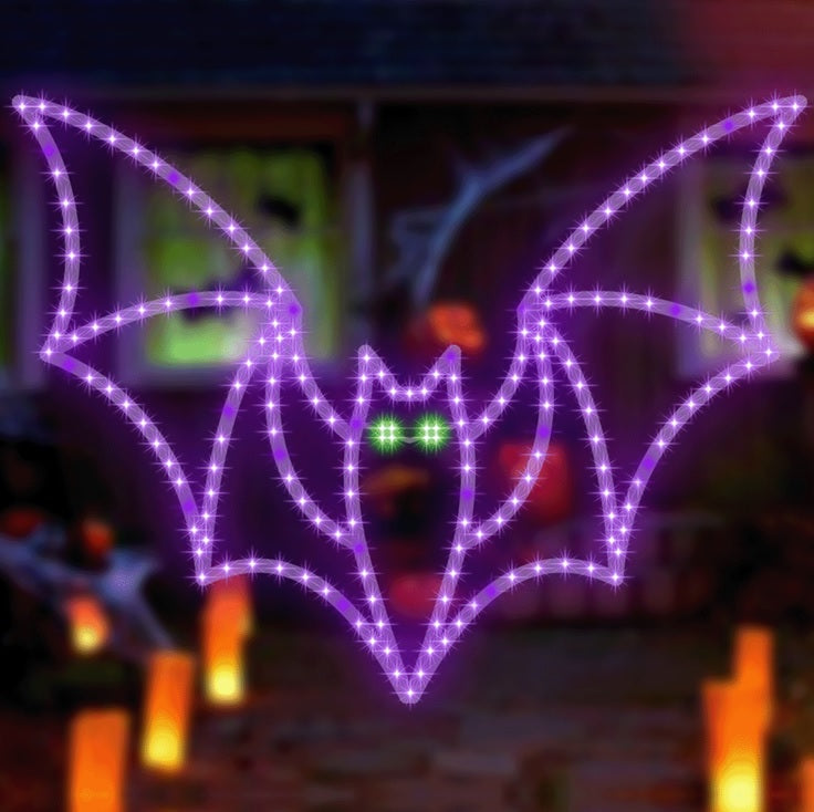 LED decoration shaped like a purple bat with bright, green eyes.