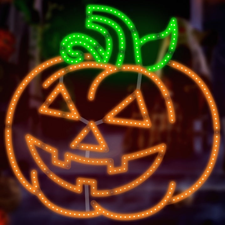 LED decoration shaped like an orange jack-o-lantern with a green stem and green leaves on top.