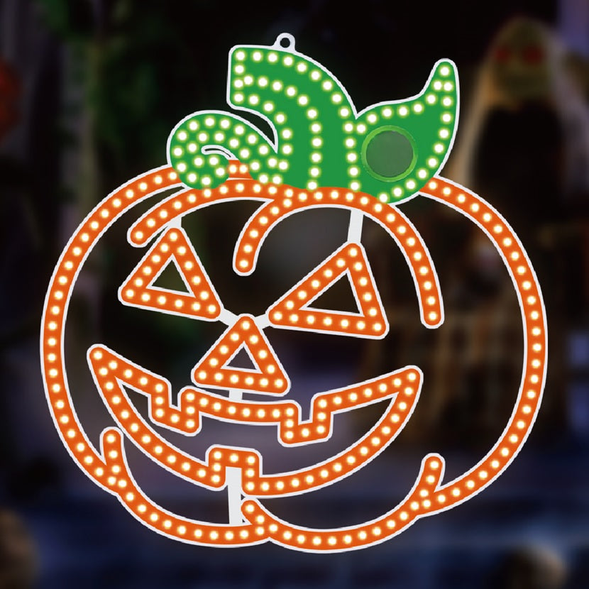 LED decoration shaped like an orange jack-o-lantern with a green stem and green leaves on top.