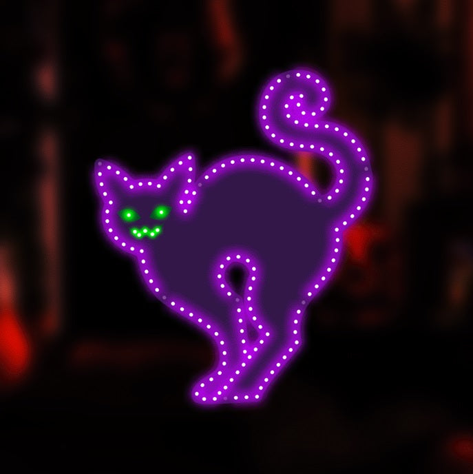 LED decoration shaped like a purple cat with bright, green eyes.