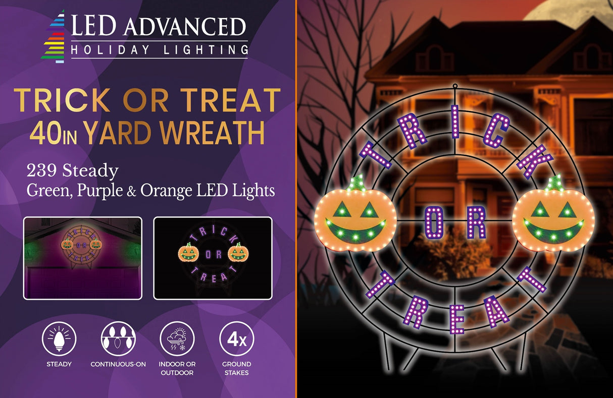 A black wire frame wreath with purple words that read "TRICK OR TREAT." There are two orange jack-o-lanterns with green eyes and mouths.