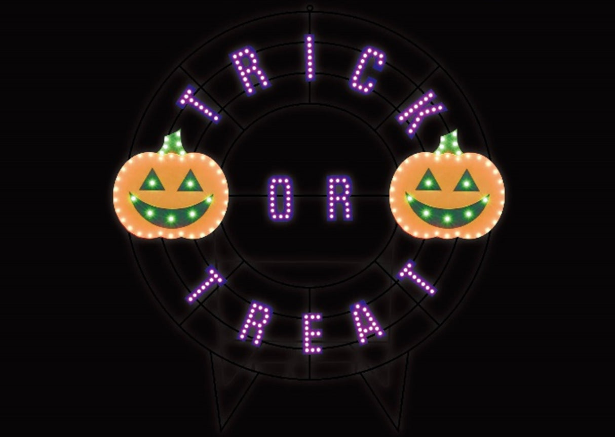 A black wire frame wreath with purple words that read "TRICK OR TREAT." There are two orange jack-o-lanterns with green eyes and mouths.