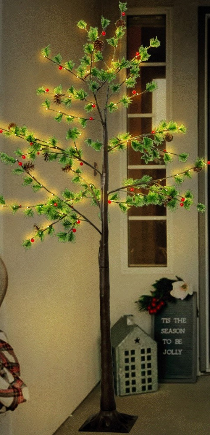 Pre-lit fake Christmas pine tree. Lights are warm white and red and the leaves are green.