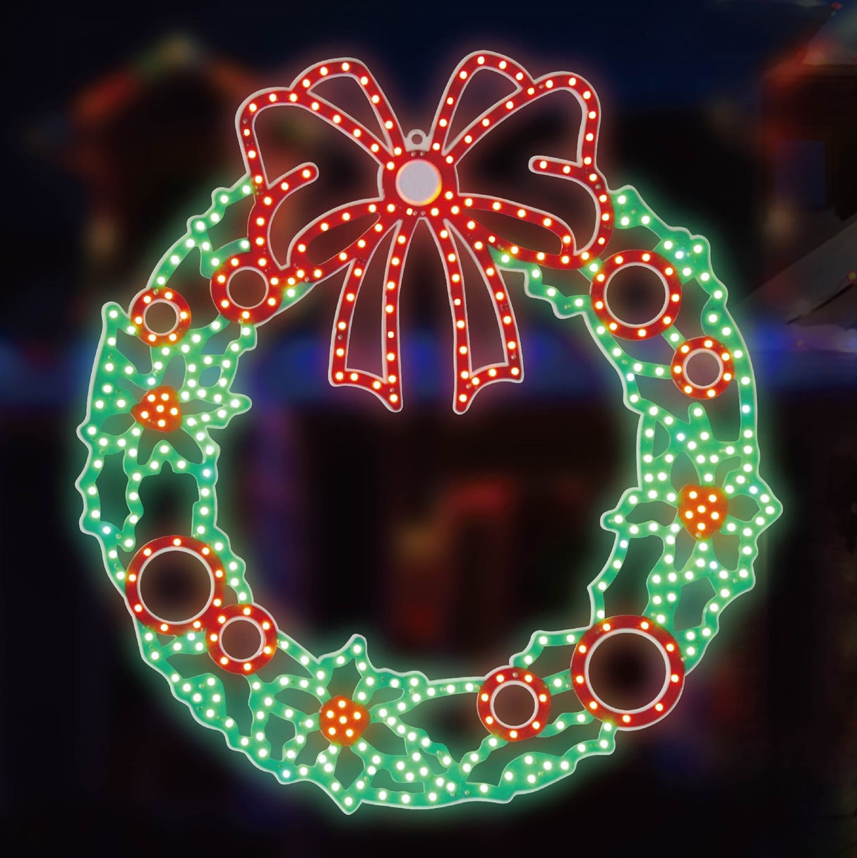 Outdoor LED decoration shaped like a wreath decorated with a red bow and berries. The lights are red and green.