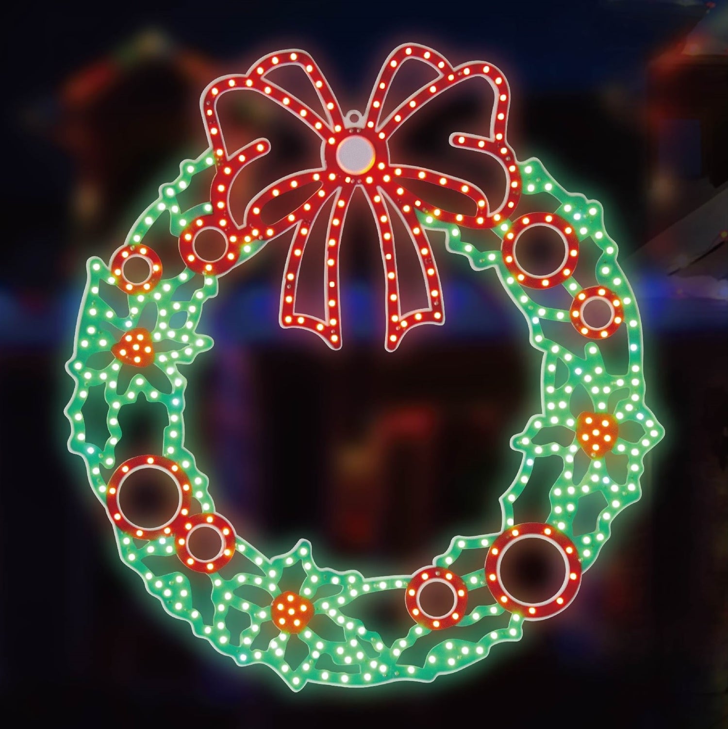 Outdoor LED decoration shaped like a wreath decorated with a red bow and berries. The lights are red and green.