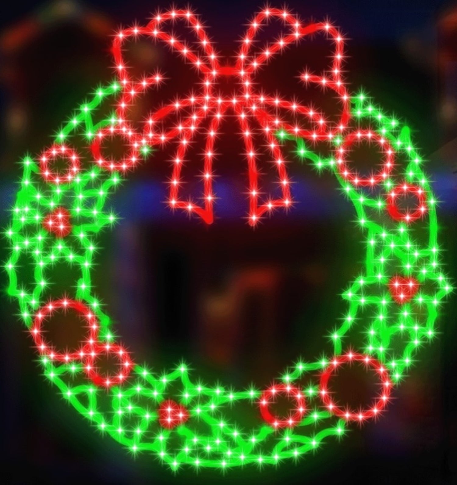 Outdoor LED decoration shaped like a wreath decorated with a red bow and berries. The lights are red and green.