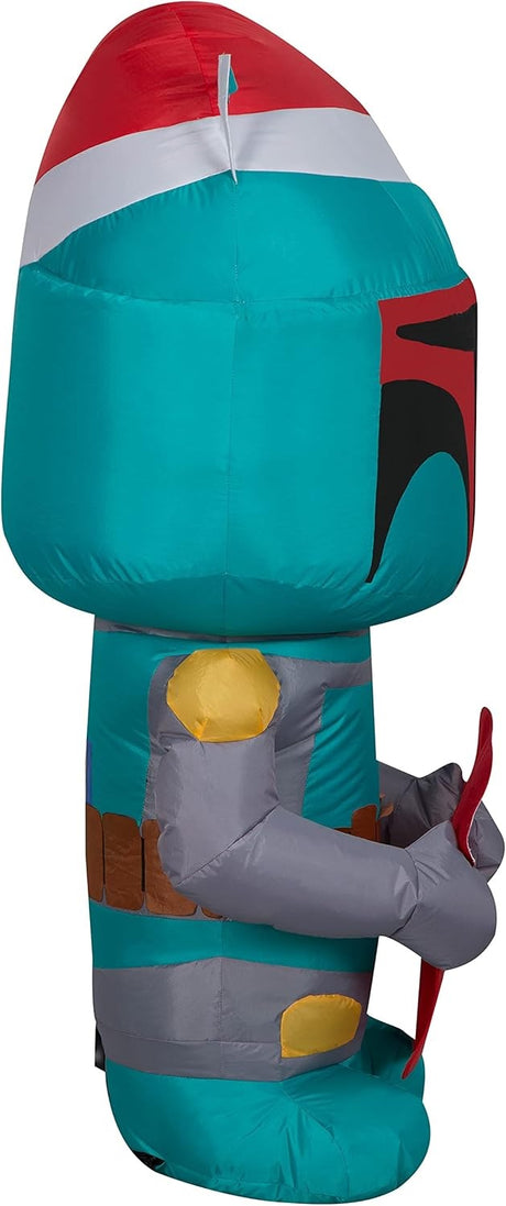 Christmas inflatable designed to look like the famous Star Wars character Boba Fett. He's wearing a Santa hat and holding a stocking with the Mandalorian symbol on it.