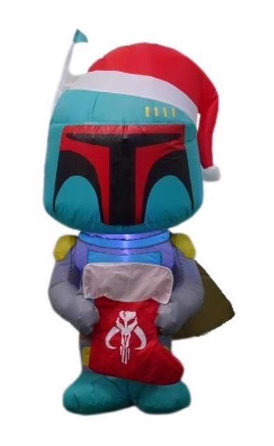 Christmas inflatable designed to look like the famous Star Wars character Boba Fett. He's wearing a Santa hat and holding a stocking with the Mandalorian symbol on it.