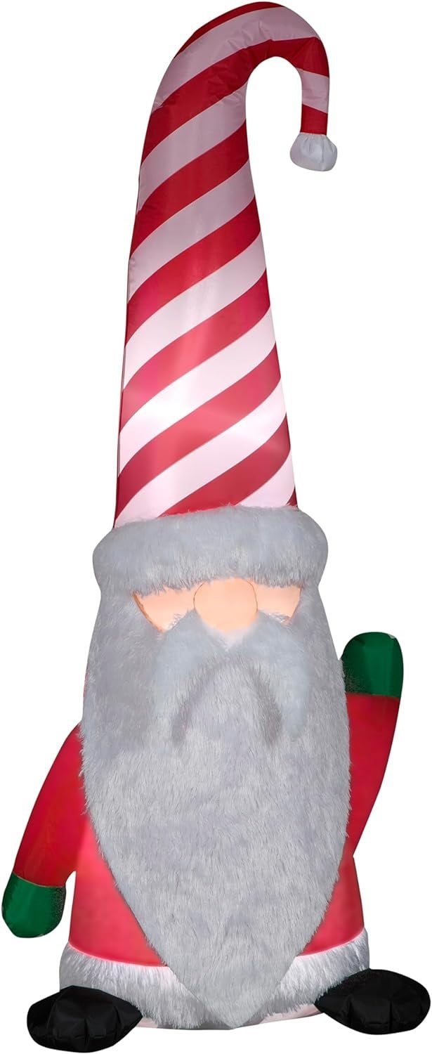 Christmas inflatable shaped like a gnome with a long white beard and a tall, red and white striped Santa hat.