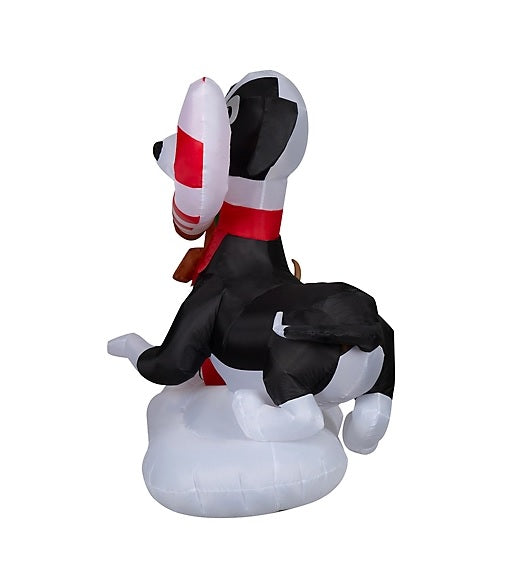 Christmas inflatable designed to look like three dogs sharing a giant candy cane. One dog is wearing a Santa hat, another one is sitting on a present and the third is wearing a red scarf.