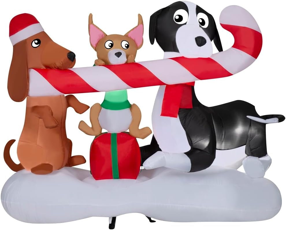 Christmas inflatable designed to look like three dogs sharing a giant candy cane. One dog is wearing a Santa hat, another one is sitting on a present and the third is wearing a red scarf.