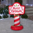 Christmas inflatable shaped like a sign that reads "Merry Christmas." The pole is red and white striped, it features a green bow and there are cute swirl accents on the sign.