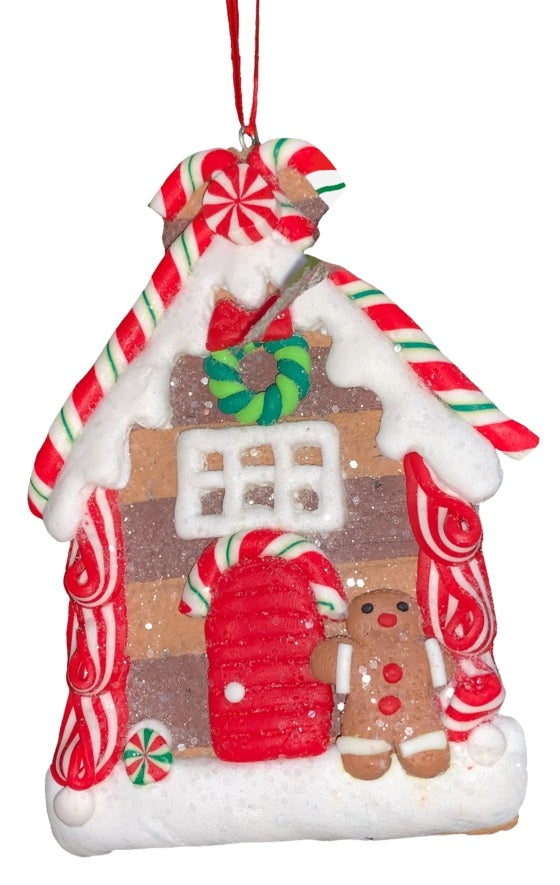 This ornament was designed to look like a gingerbread cookie house covered in sugar. This specific ornament has long red, green and white candy canes on the roof and features a gingerbread man on the right side of the front door.