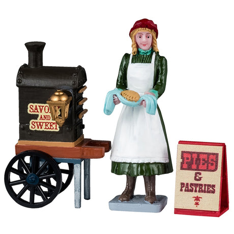 Resin figurines for a Lemax tabletop display. Designed to look like a woman serving pies from a food cart. The cart reads "Savory and Sweet." The sign on the ground reads "Pies & Pastries."