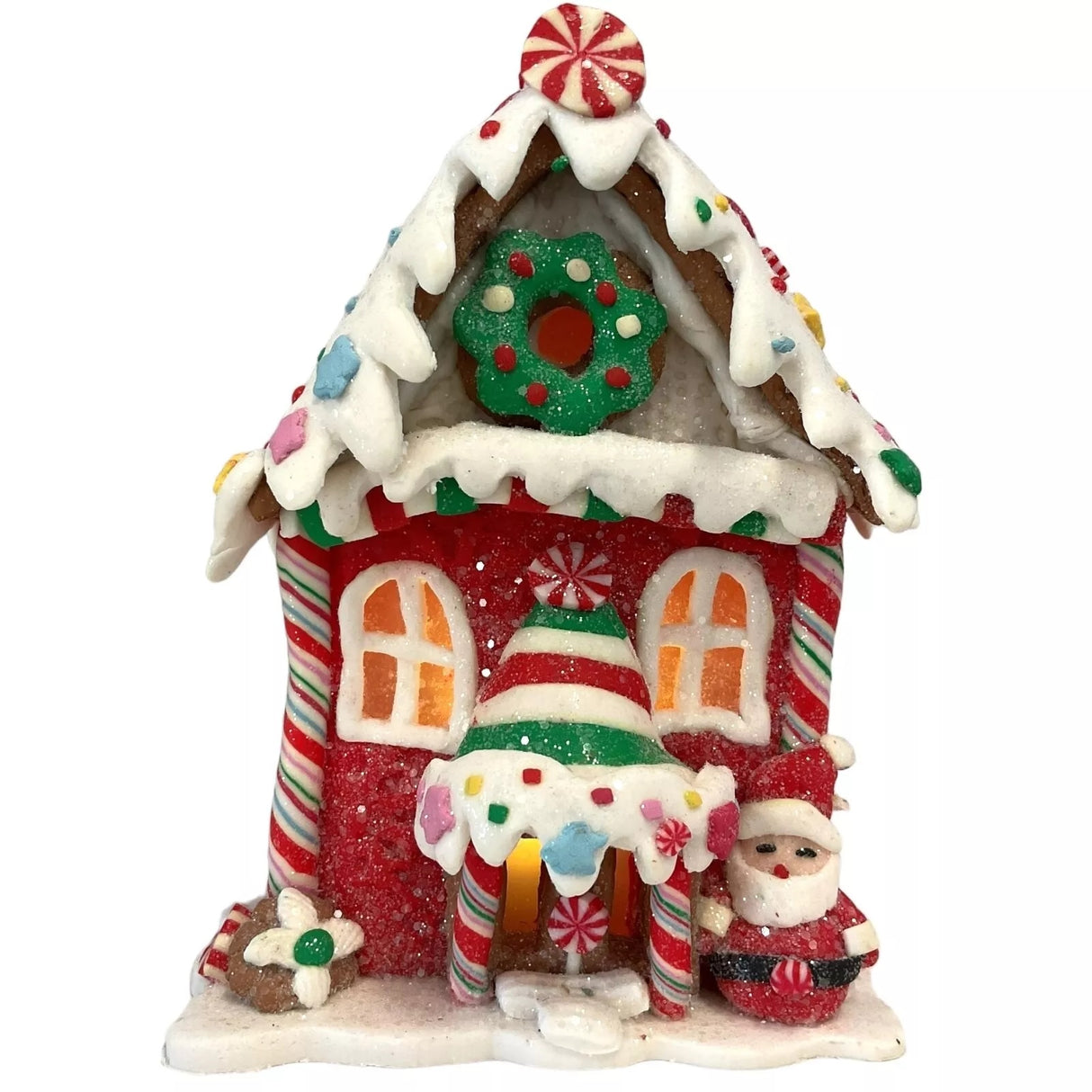 Decorative piece designed to look like a gingerbread covered in candies and frosting. This one has a flower and a Santa Claus accent near the front door.