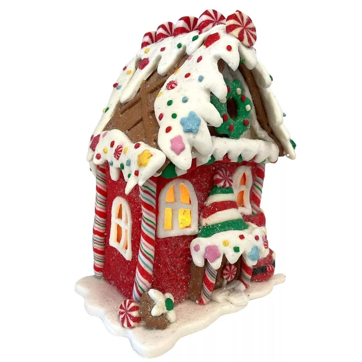 Decorative piece designed to look like a gingerbread covered in candies and frosting. This one has a flower and a Santa Claus accent near the front door.
