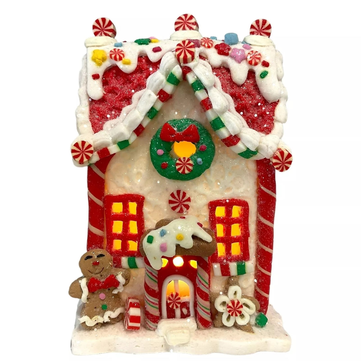 Decorative piece designed to look like a gingerbread covered in candies and frosting. This one has a gingerbread person and a flower accent near the front door.