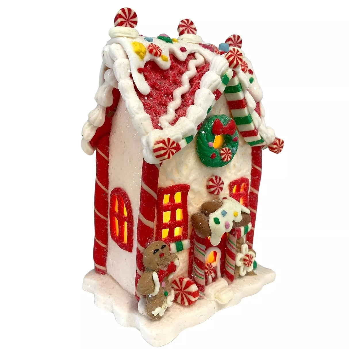 Decorative piece designed to look like a gingerbread covered in candies and frosting. This one has a gingerbread person and a flower accent near the front door.