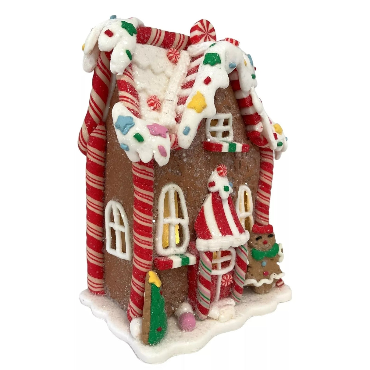Decorative piece designed to look like a gingerbread covered in candies and frosting. This one has a tree and a gingerbread person accent.