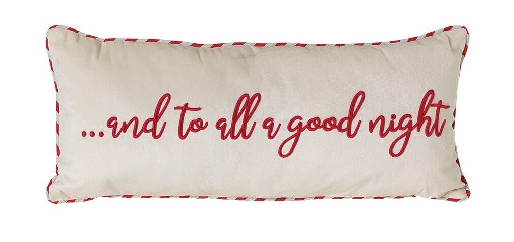 White pillow that reads "...and to all a good night" in red, cursive text. The border is red and white striped.